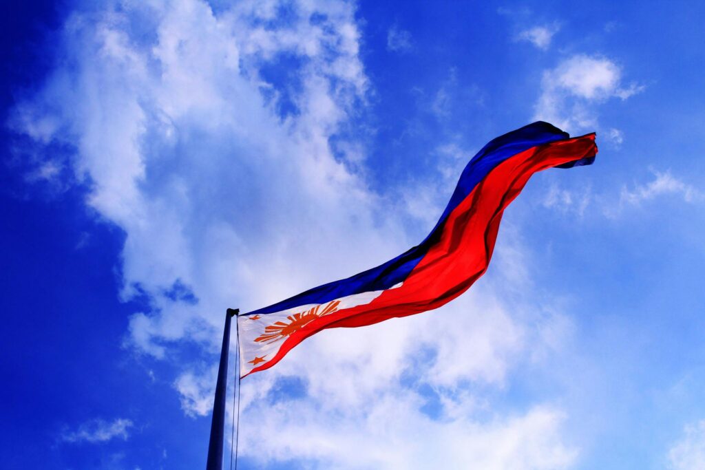 The Philippine flag waves proudly against a bright blue sky, symbolizing patriotism, freedom, and the rich cultural heritage of the Philippines. With the PinayPal dating app, you can connect with Filipinas who value tradition and share the same deep sense of pride in their roots. Join PinayPal today and celebrate love, friendship, and Filipino culture.